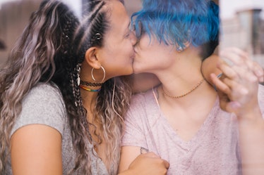 Young lesbian couple kissing and showing affection. Multicultural love without boundaries.