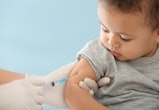 Doctor vaccinating a toddler in the upper arm.