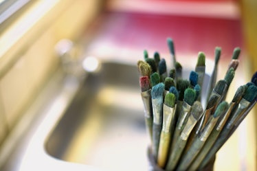 View of paint brushes in a cup against blurred background