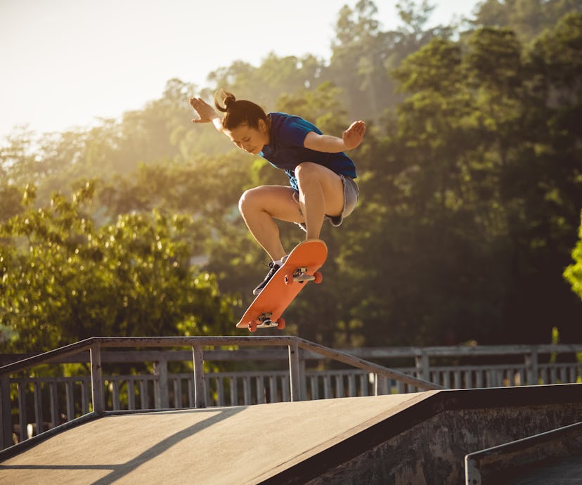 Skateboarder skateboarding at skatepark ramp. A woman hula hoops. These nostalgic outdoor activities...
