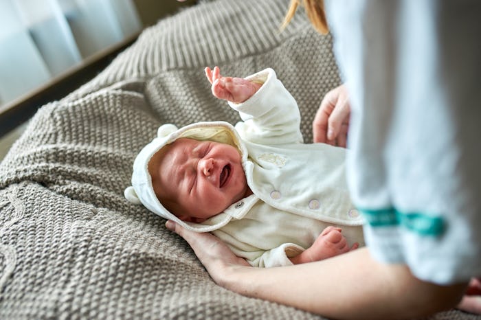 Newborn crying baby.New born child tired and hungry in bed.Children cry.Bedding for kids.Infant scre...