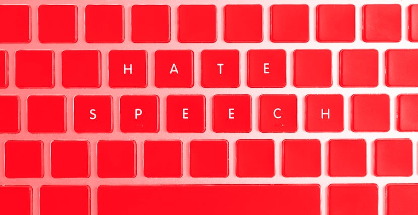 Concept of problems of today internet. Hate speech caption isolated on notebook keyboard with blank ...