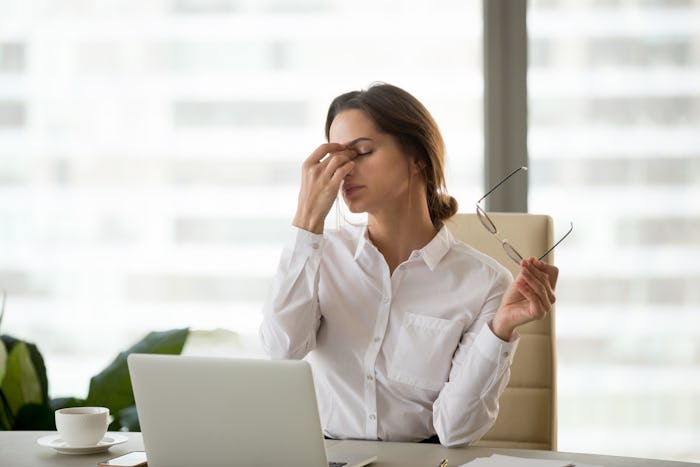 Fatigued businesswoman taking off glasses tired of computer work, exhausted employee suffering from ...