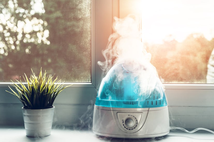 Air humidifier during work. The white humidifier moistens dry air. Improving the comfort of living i...