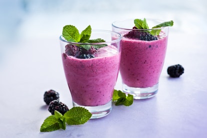 Delicious blackberry smoothie with mint and fresh berries in glasses
