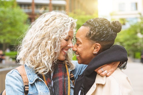Happy multiracial girlfriends in love embracing and cuddling - Lesbian couple, millennials women, gi...