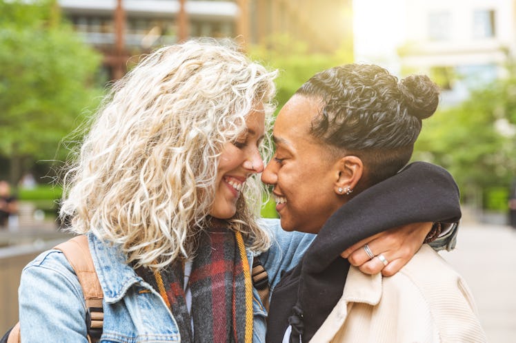 Happy multiracial girlfriends in love embracing and cuddling - Lesbian couple, millennials women, gi...