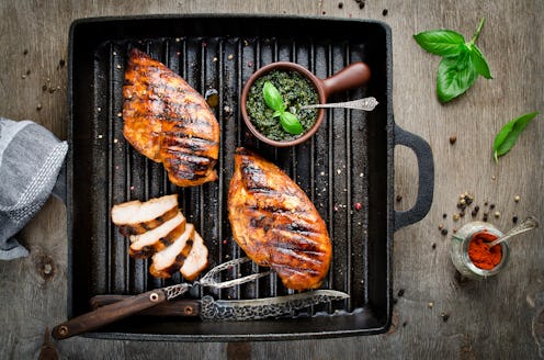 Chicken fillet in the grill pan. Grilled meat with pesto sauce