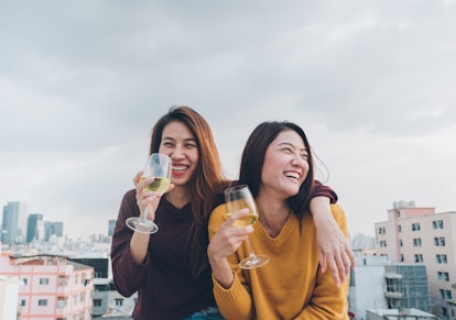 Happy asia girl friends enjoy laughing and cheerful sparkling wine glass at rooftop party,Holiday ce...