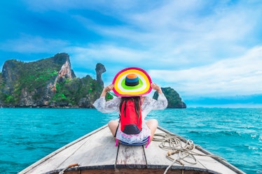 Summer lifestyle traveler woman in bikini and big hat joy relaxing on boat, Kai island, Andaman sea,...