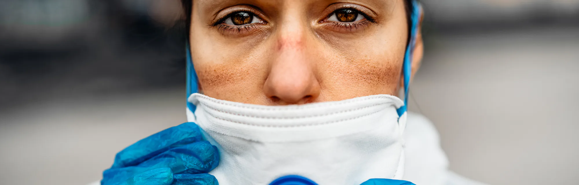 Exhausted doctor/nurse wearing coronavirus protective gear N95 mask uniform.Coronavirus Covid-19 out...