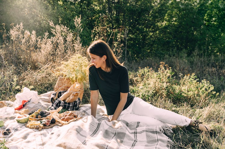 Beautiful young girl on a picnic on a summer day. concept of leisure, vacation, tourism outdoorsy