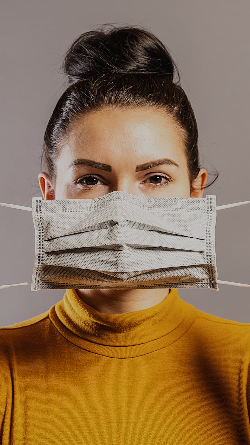 Woman wearing an anti virus protection mask to prevent others from corona COVID-19 and SARS cov 2 in...