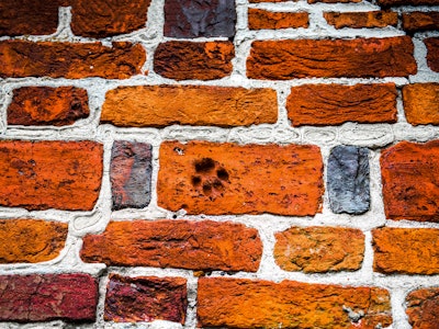 Footprint on red brick wall. Red brick wall footprint. Red brick wall texture. Brick wall footprint