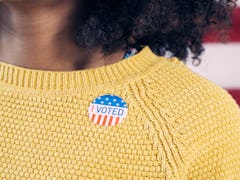 Young Gen Z Voter Wearing Sticker After Voting in Election