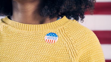 Young Gen Z Voter Wearing Sticker After Voting in Election