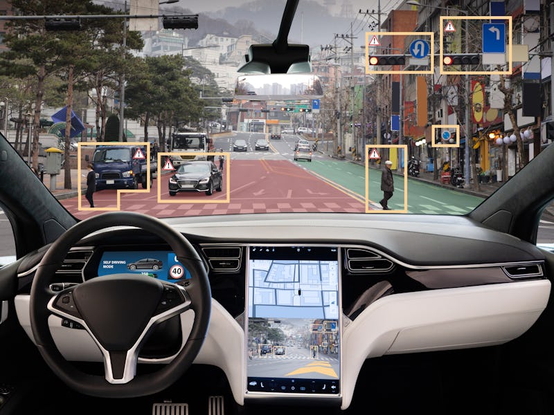 Autonomous car with HUD (Head Up Display). Self-driving vehicle on city street
