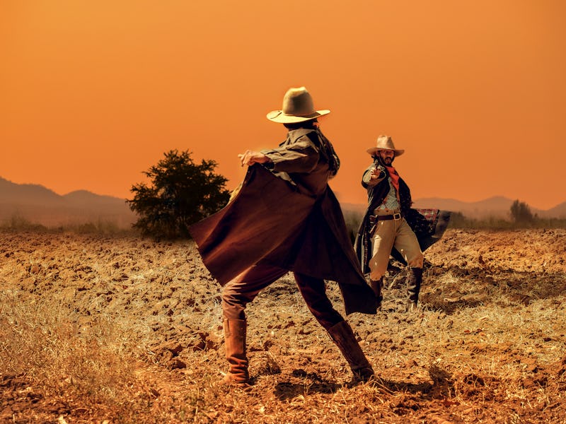 Cowboy Life: pistol shooting in a cowboy action shooting competition under sunset ,duel between cowb...