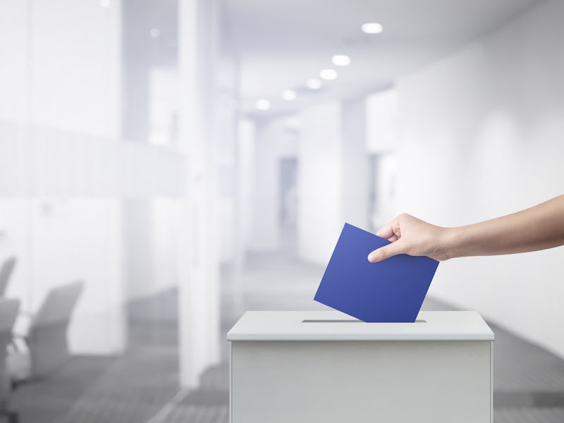 Woman person vote with ballot box at office voting concept.