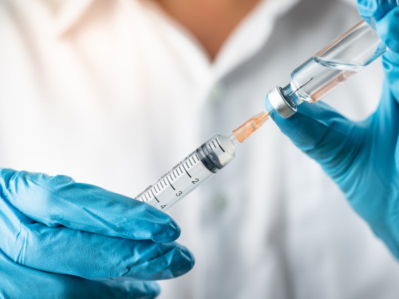 Doctor, nurse, scientist, researcher hand in blue gloves holding flu, measles, coronavirus, covid-19...