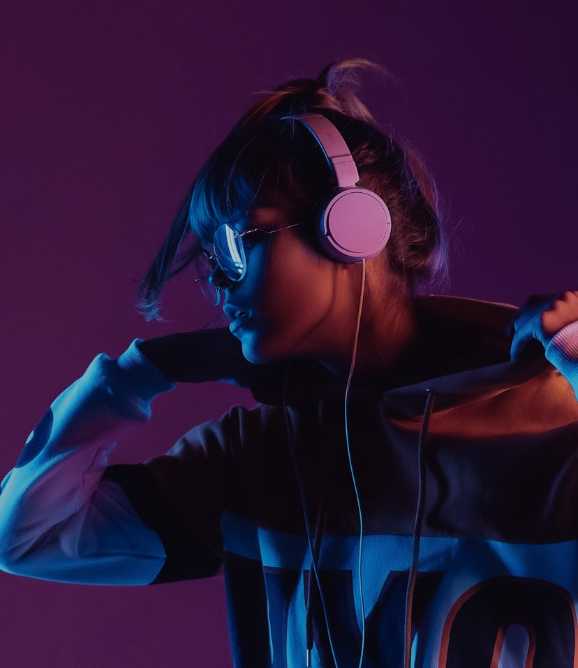 Hipster igen teen pretty fashion girl model wear stylish glasses headphones enjoy listen new cool mu...