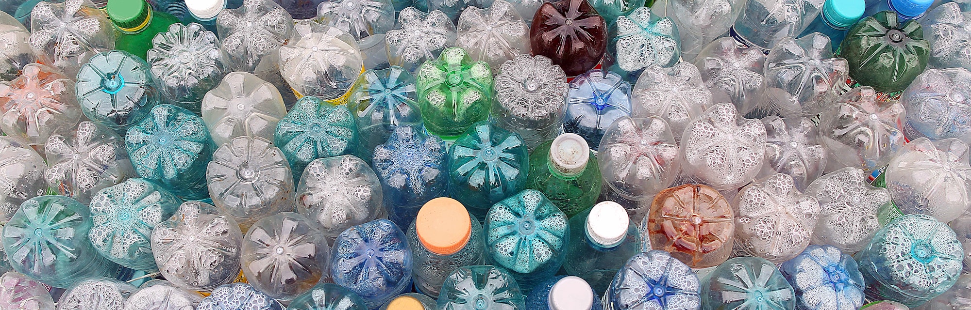 Dirty used colored plastic bottle pile ready to be recycled