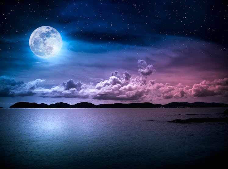 Beautiful landscape view of the sea with many stars . Attractive dark sky with cloud and  full moon ...