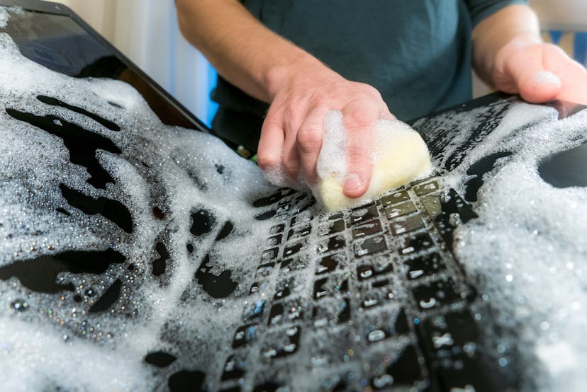 Cleaning the hard drive concept. Washing the laptop with dish soap.
Also a symbol for making a big m...
