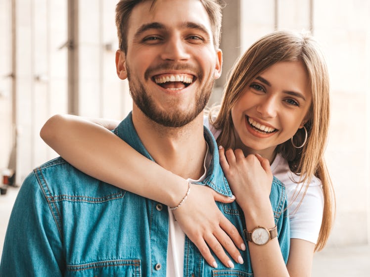 Portrait of smiling beautiful girl and her handsome boyfriend. Woman in casual summer jeans clothes....