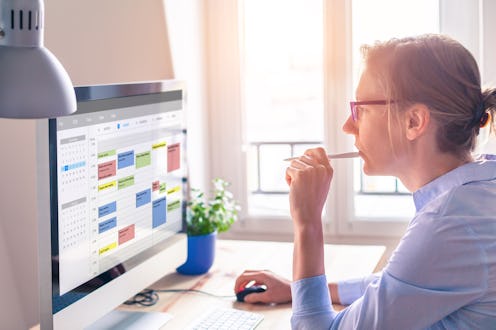 Person using calendar on computer to improve time management, plan appointments, events, tasks and m...