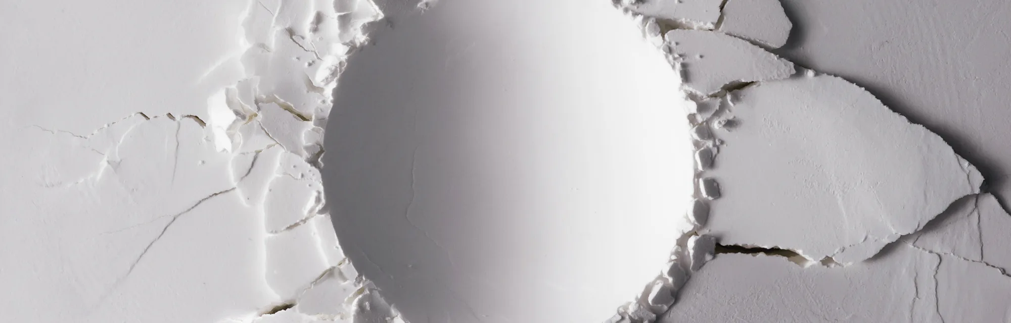 White powder texture with round impact crater. Minimalism flat lay.