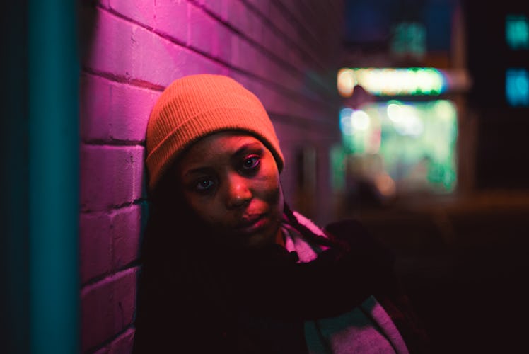 Portraits of a young black lady under colourful light