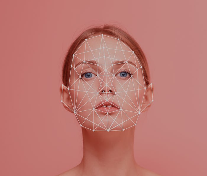 Facial recognition security system. Face augment mobile phone technology concept. Woman portrait loo...