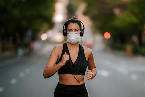 girl does sports with mask on the street during coronavirus