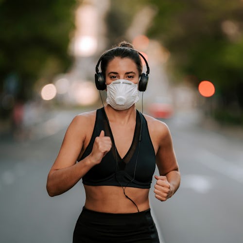 girl does sports with mask on the street during coronavirus