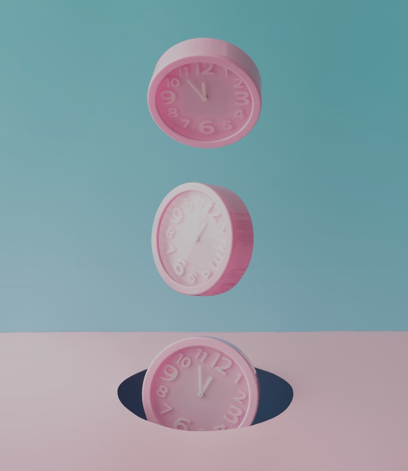 Pastel pink wall clocks on blue backdrop falling down. Time concept. Minimal composition.