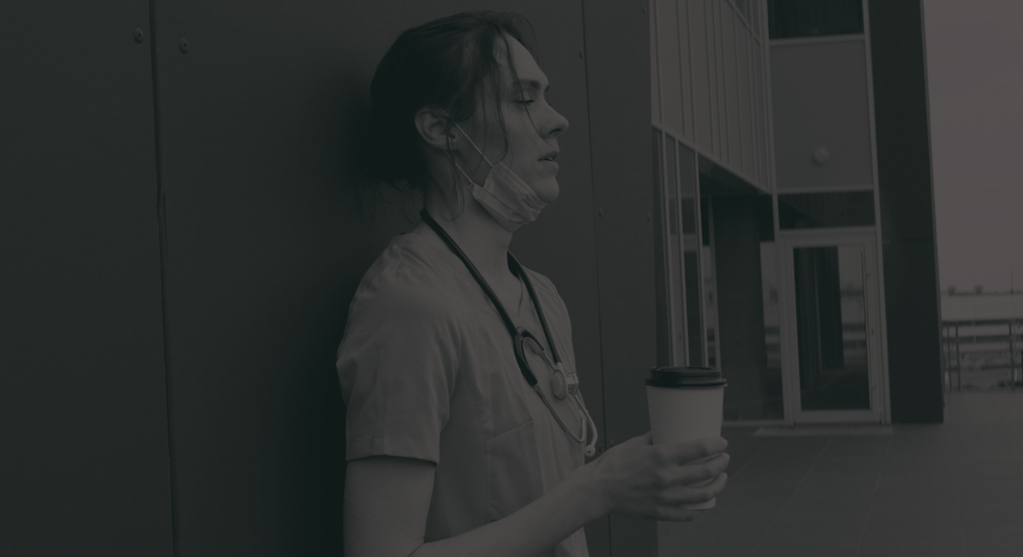 Portrait of tired exhausted nurse or doctor having a coffee break outside in the morning. COVID-19, ...