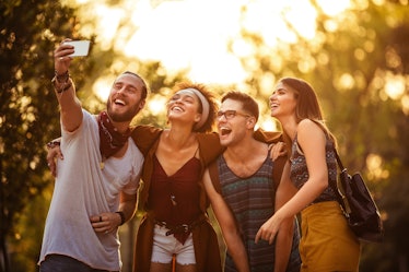 Group of friends taking selfie on their way to festival