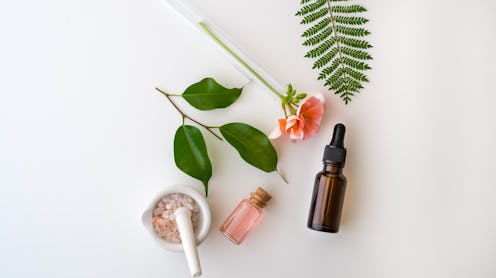 Cosmetic package containers with green leaves, pink salt,herbal . natural  organic beauty product co...