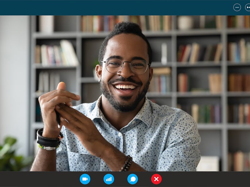 Headshot portrait screen application view of overjoyed young African American man sit at home have p...