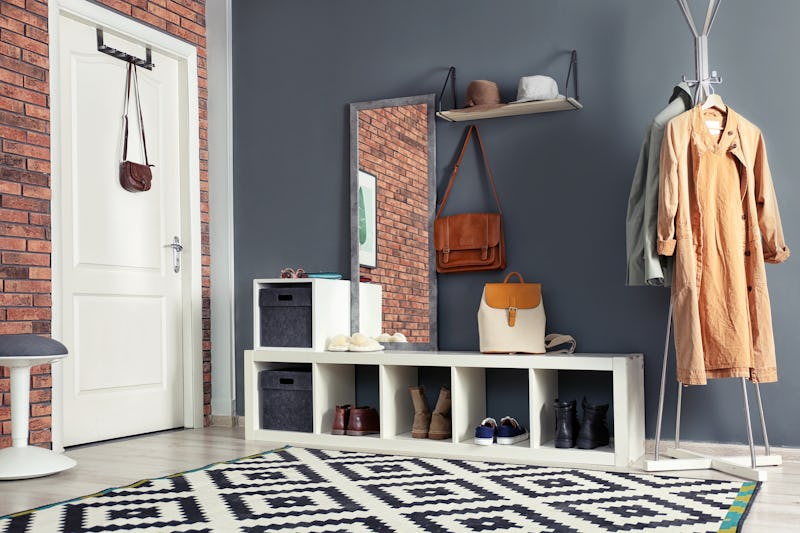 Stylish hallway interior with mirror and hanger stand