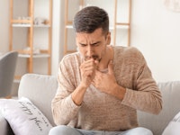 Coughing young man at home