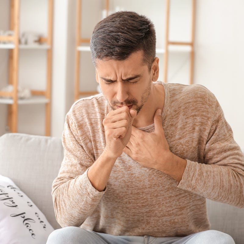 Coughing young man at home