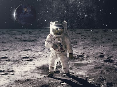 Astronaut on rock surface with space background. Elements of this image furnished by NASA