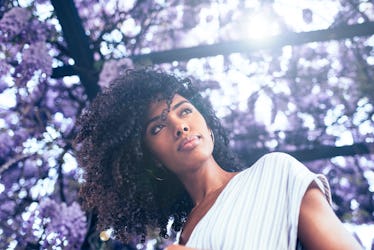 Young black woman surrounded by flowers