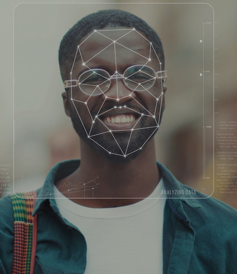 A portrait of a young Black man can be seen. He is wearing a denim jacket, eyeglasses, a white shirt...