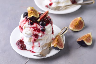 Mini Pavlova Cake with Figs and Berry Tasty Dessert Pavlova on White Plate White Cup of Tea and Whit...