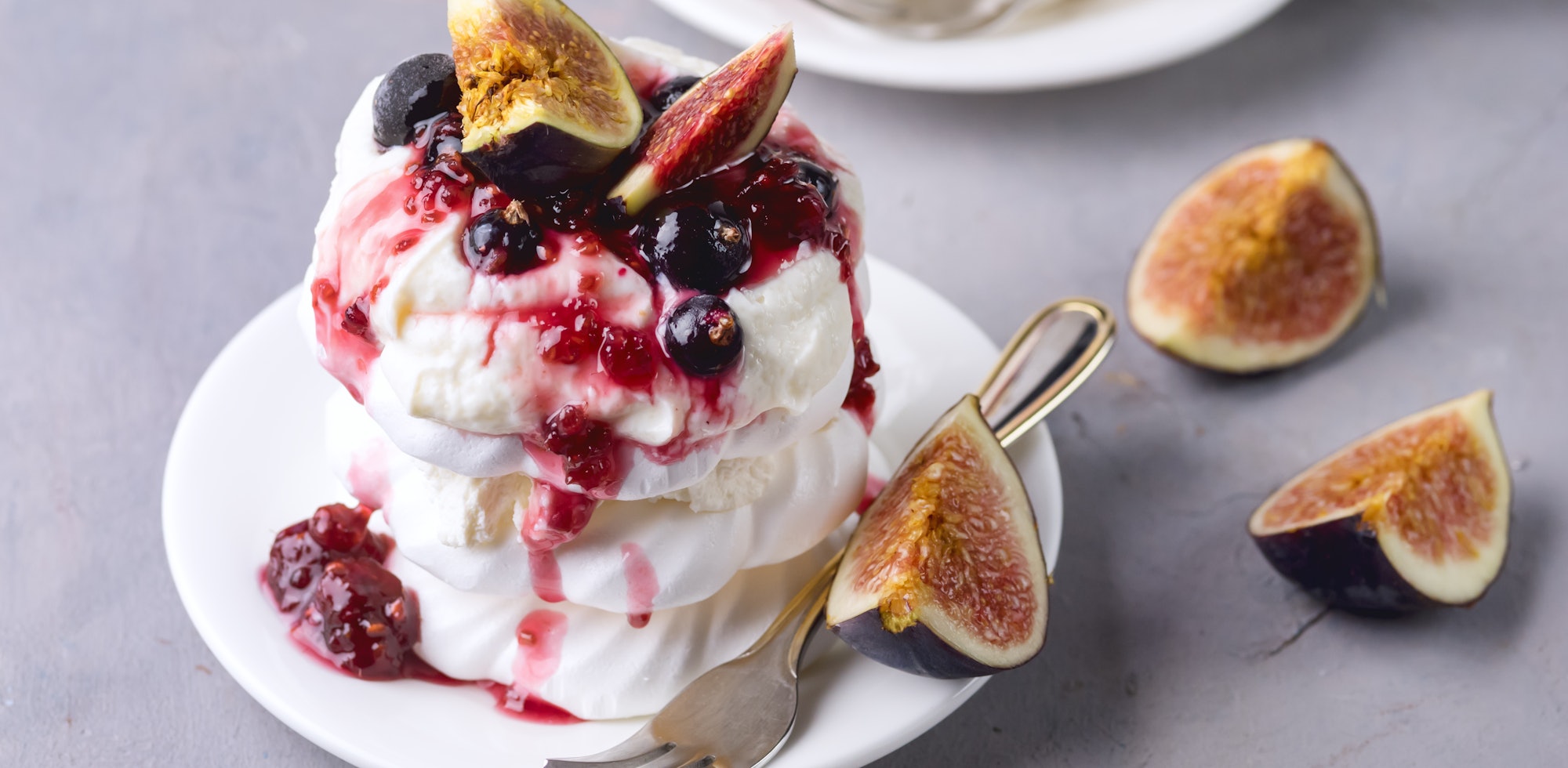 Mini Pavlova Cake with Figs and Berry Tasty Dessert Pavlova on White Plate White Cup of Tea and Whit...