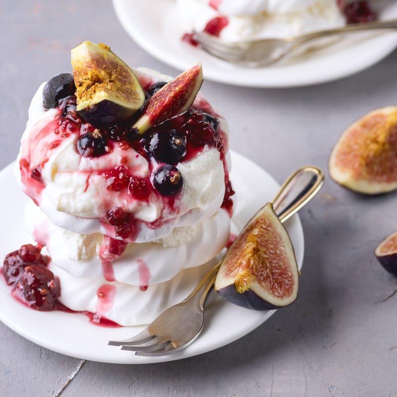 Mini Pavlova Cake with Figs and Berry Tasty Dessert Pavlova on White Plate White Cup of Tea and Whit...