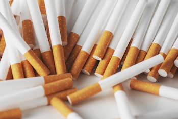 Close up of a smoking cigarettes . cigarette filter tubes